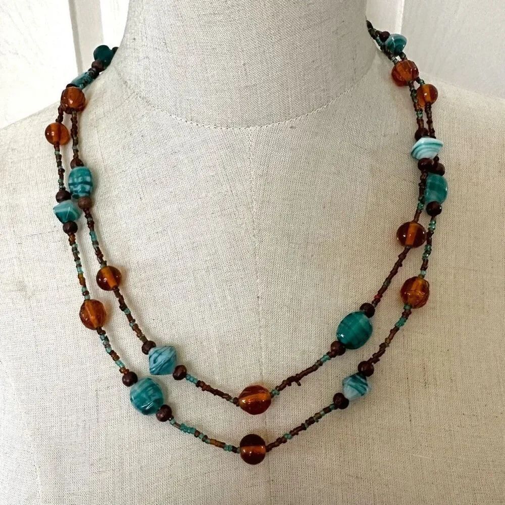 Blue and amber tone long glass beaded necklace